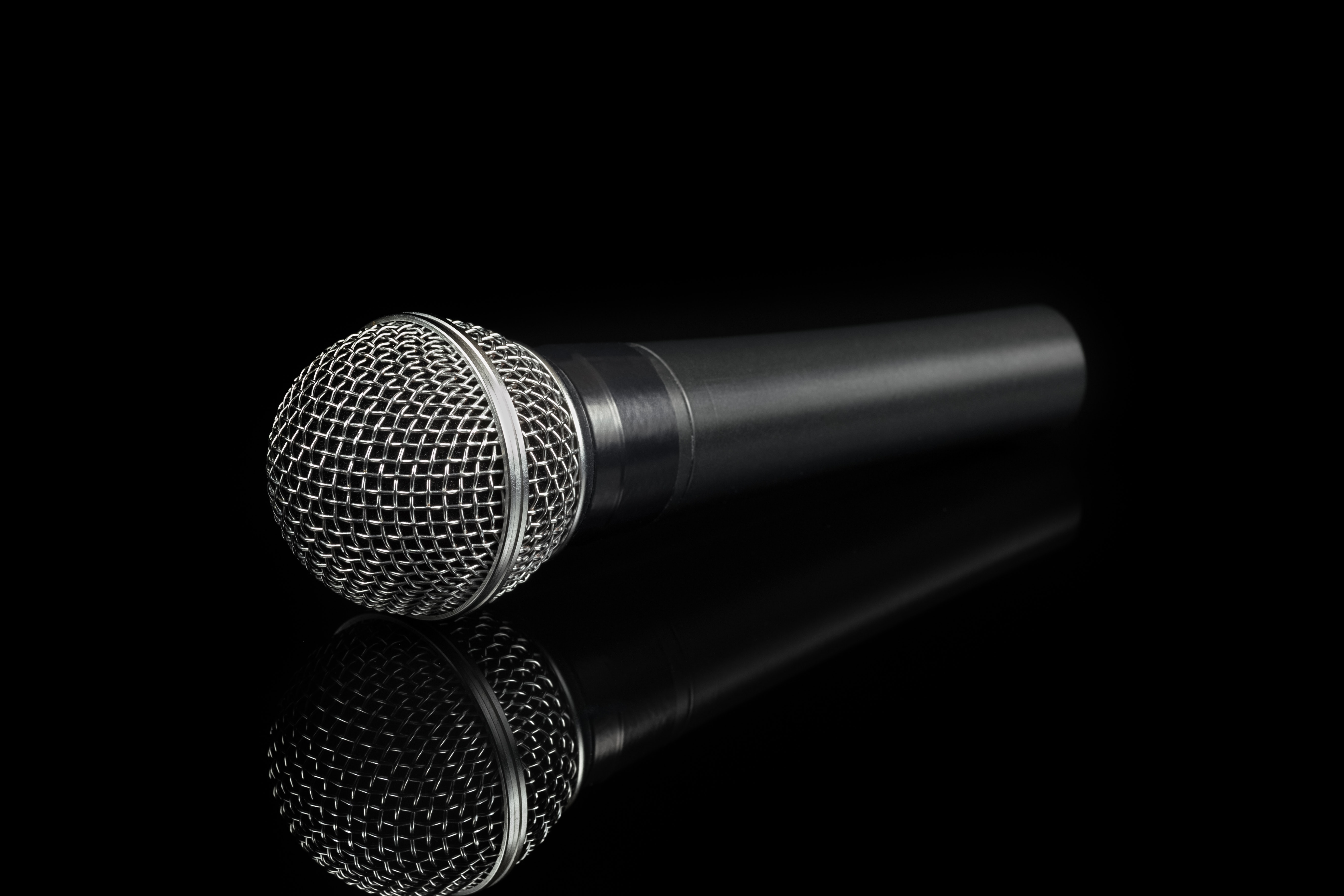 black-and-gray-dynamic-microphone-on-reflective-surface-3531975.jpg